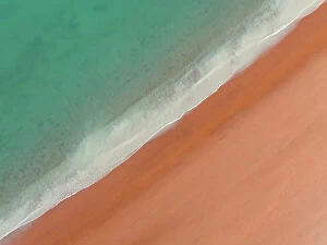 Images Dated 12th July 2023: Drone shot looking down on calm waves washing onto Simpson Beach, Broome, Western Australia