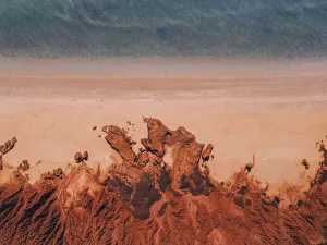 Drone shot showing majestic rock formations, a beach and the ocean, James Price Point Drone shot showing majestic rock formations, a beach and the ocean, James Price Point