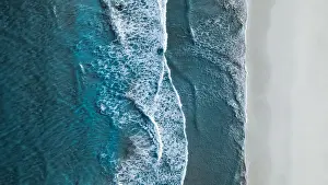 Drone shot showing waves rolling onto a beach, Esperance, Australia