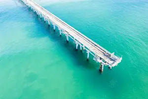 Vicki Smith Australian Landscape Photography Prints: Drone view of a Long sand pumping jetty out into the clear ocean water