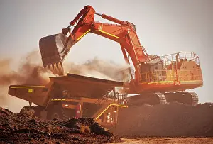 Excavator loads mine truck