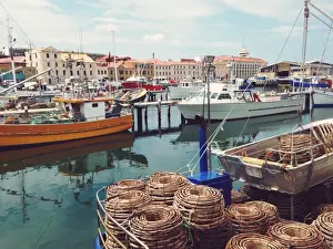 Jodie Griggs Prints: Fishing boats moored at a wharf in a city