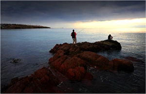 Fishing at dusk near on the coastline at Hallett cove, Adelaide, South Australia Fishing at dusk near on the coastline at Hallett cove, Adelaide, South Australia