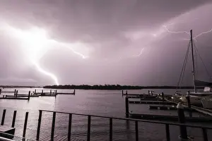 Images Dated 12th November 2020: Flashes of bright lightning strikes across the water with boats silhouetted