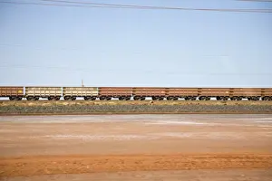 Freight train moving through a desert landscape, Port Hedland, Western Australia, Australia