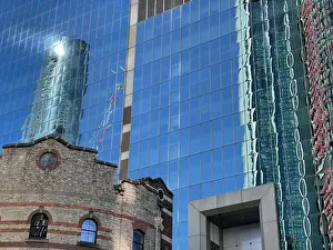 Glass office block and old brick historic building facade, Sydney, Australia