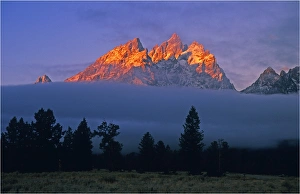 The kiss of dawn sunlight over the mountains in the Grand Teton National Park, Wyoming The kiss of dawn sunlight over the mountains in the Grand Teton National Park, Wyoming