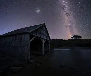 lake and boast shed under night sky tasmania