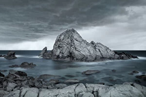 Images Dated 15th September 2023: Large Coastal Rock Feature Against Dramatic Skies