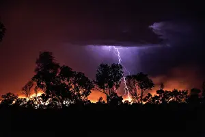 Lightning fork striking a bushfire photographed at night, The Kimberley, Western Australia, Australia