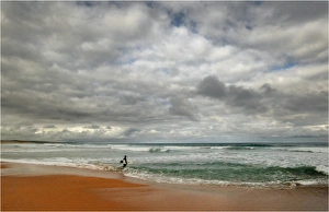 A lone surfer and coastal view, shipwreck coastline, Victoria, Australia A lone surfer and coastal view, shipwreck coastline, Victoria, Australia
