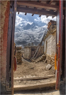 Looking out a temple doorway in Karkhot Jompa to the mountains, Mustang, Nepal Looking out a temple doorway in Karkhot Jompa to the mountains, Mustang, Nepal