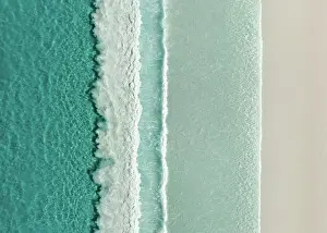 Aerial Beach Photography Prints: Majestic drone image looking down on rows of Ocean waves rolling onto an idyllic beach
