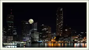 Full Moon Prints: Moon rises over darkened cityscape