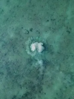Aerial Beach Photography Prints: Ocean floor disturbed by a fish moving shot from a drone point of view