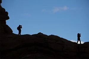 Images Dated 4th November 2014: Photographers silhouretted against the sky in the Arches national park, Utah, USA