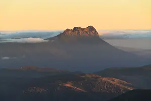 Precipitous Bluff rising above Southwest Tasmania at sunset viewed from Mt Geeves