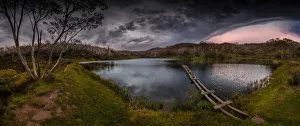 Rainbow lake in the summer with a passing storm, Snowy mountains Rainbow lake in the summer with a passing storm, Snowy mountains