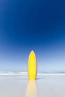 Retro Styled Prints: Retro yellow surf board and blue sky. Australia