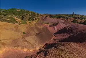 The rich red and ochre hues of the scarred landscape on Phillip island, situated just off Norfolk Island, south pacific ocean