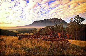 Rusting old agricultural machinery sitting in a filed near Mount Roland, Central Tasmania