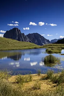 Sassolungo reflecting in a lake