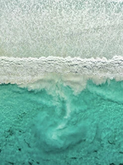 Abstract Aerial Art Collection: Sediment swirling behind a breaking Ocean wave photographed from directly above