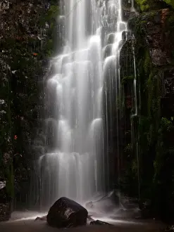 Small waterfall with rock