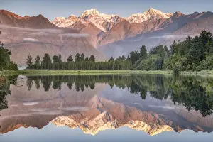 Snowy mountain peaks of Mount Cook and Mount Tasman reflected in Lake Matheson in