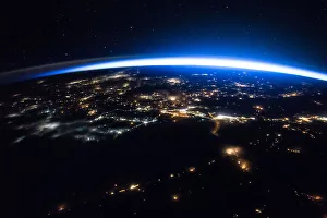 Sparkling cities and a sliver of daylight framing the northern hemisphere