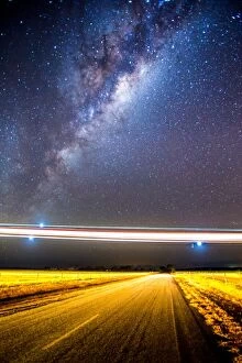 Images Dated 26th May 2015: Stargazing; Lights of a low flying plane over an outback Australian road
