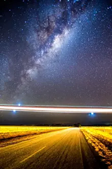 Stargazing; Lights of a low flying plane over an outback Australian road