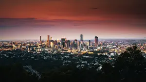 Prints of It was a peaceful twilight when the sunset. Clouds cast some shadows on the brick-red sky hanging above the contemporary skyscrapers in Brisbane CBD Queensland (QLD) Prints: Stunning sunset above Brisbane CBD viewing from Mount Coot-tha Lookout
