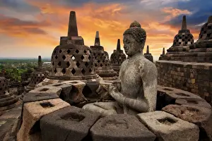 Business Finance And Industry Prints: Sunrise with a Buddha Statue with the Hand Position of Dharmachakra Mudra in Borobudur