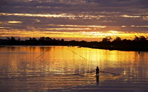 Sunset reflections with rower on Lake Wendouree Ballarat, Victoria, Australia Sunset reflections with rower on Lake Wendouree Ballarat, Victoria, Australia