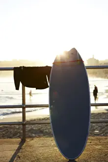 Surfboard leaning against railing