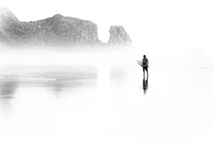 Surfer at Bethells Beach (Te Henga) on Aucklands west coast