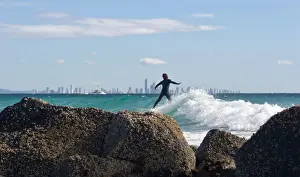 Prints of Surfers riding the waves off the rocks at Currumbin with the cityscape of Surfers Paradise as their background Marianne Purdie Photography Prints: Surfing the waves