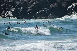 Prints of Surfers riding the waves off the rocks at Currumbin with a rockwall as their background Marianne Purdie Photography Prints: Surfing the waves