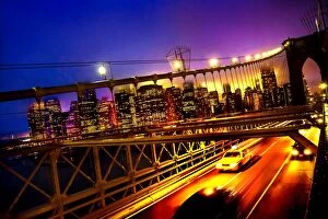 Images Dated 17th September 2017: A tilted view of a yellow cab speeding along the Brooklyn Bridge at dusk