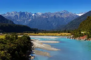 Prints of Westland Tai Poutini National Park New Zealand Prints: Turquoise-colored Whataroa River with snowcapped Southern Alps on horizon on autumn