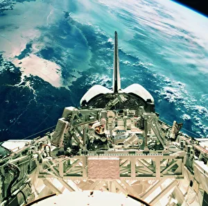 View of the tail section of the space shuttle orbiting above earth View of the tail section of the space shuttle orbiting above earth