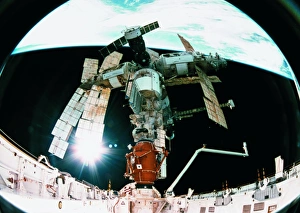View from a wide angle lenses of a space station docking in orbit View from a wide angle lenses of a space station docking in orbit