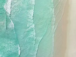 Waves from the Southern Ocean washing onto a beach shot from a drone perspective, Esperance, Western Australia, Australia