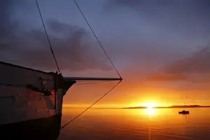 Coastal Prints: Wooden sailing boat and sunrise